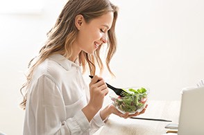 young woman eating salad 