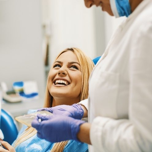 Blonde woman grinning at her dentist