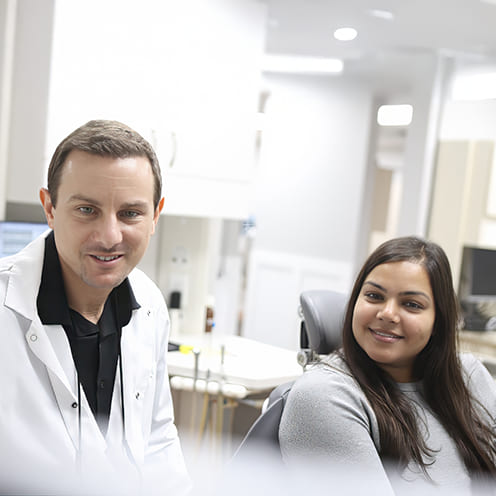 Doctor Young and dental assistant treating a dental patient