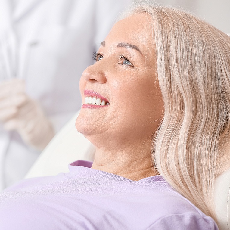 patient smiling while visiting dentist 