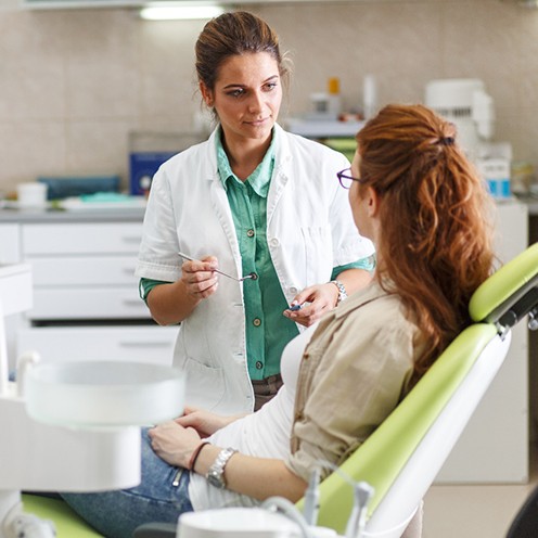 A dentist talking with her patient about direct bonding