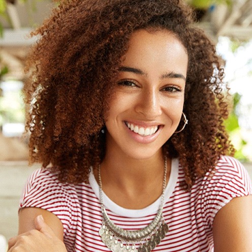 woman smiling while sitting inside