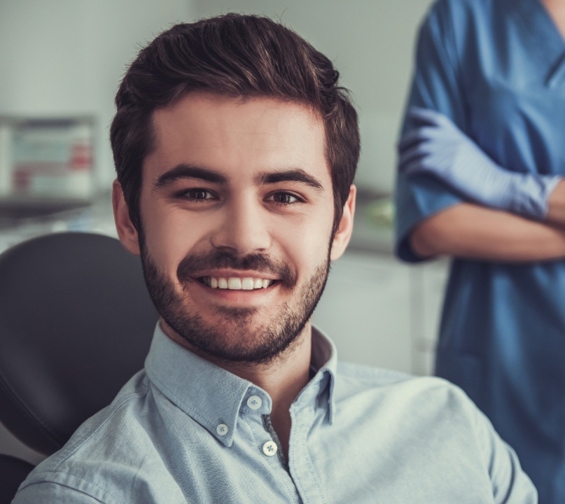 Young man smiling in dental chair while visiting cosmetic dentist in Palos Heights