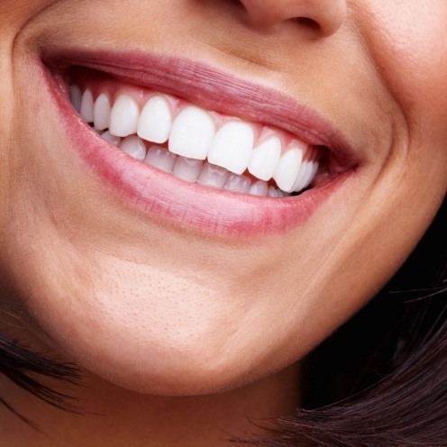 Close up of woman smiling with straight white teeth