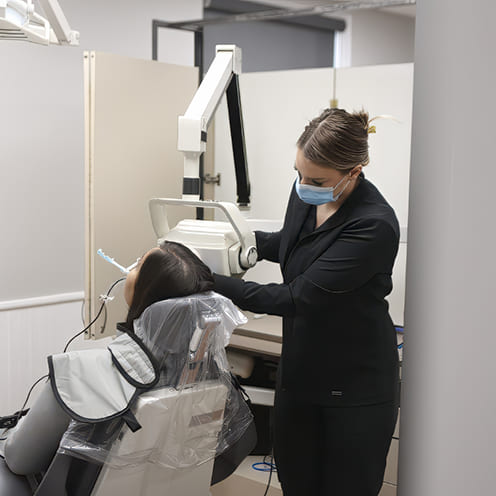 Doctor Young pointing to computer screen showing digital dental x rays