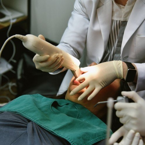 Dental team member capturing digital dental impressions of teeth