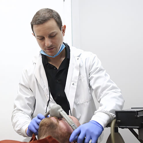 Doctor Young and dental team member treating emergency dental patient