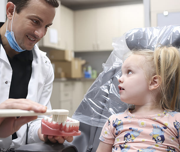 Doctor Young and dental assistant treating a dental patient