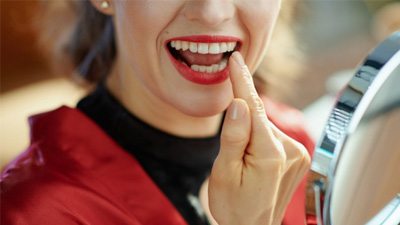 Lady admires her dental implant