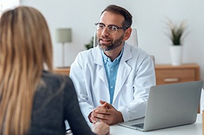 dentist talking to patient about financing options 