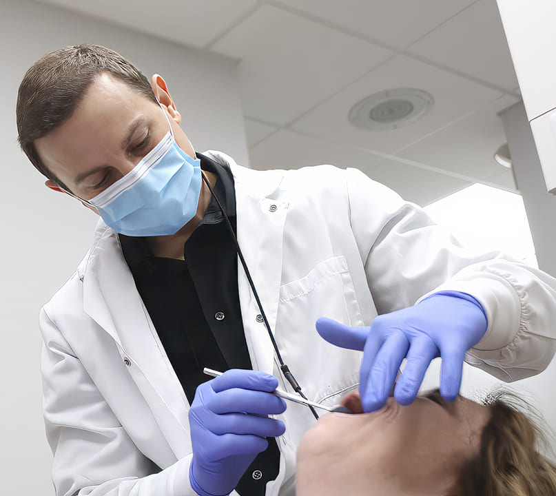 Doctor Young and dental assistant providing dental services in Palos Heights