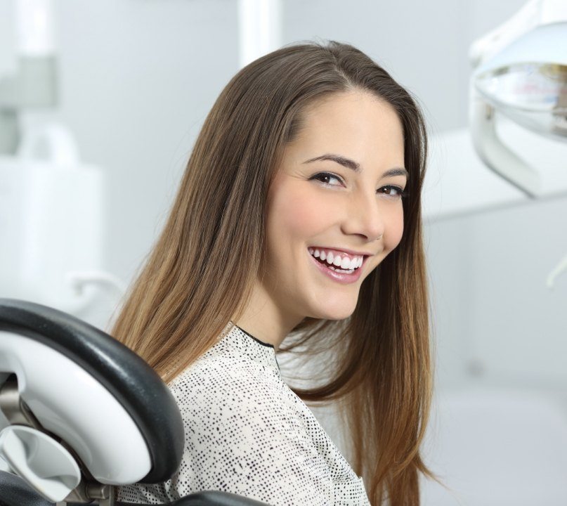 Woman smiling during preventive dentistry checkup