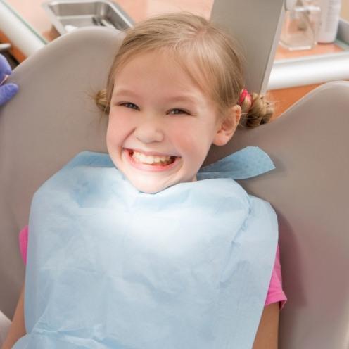 Young girl grinning in dental chair