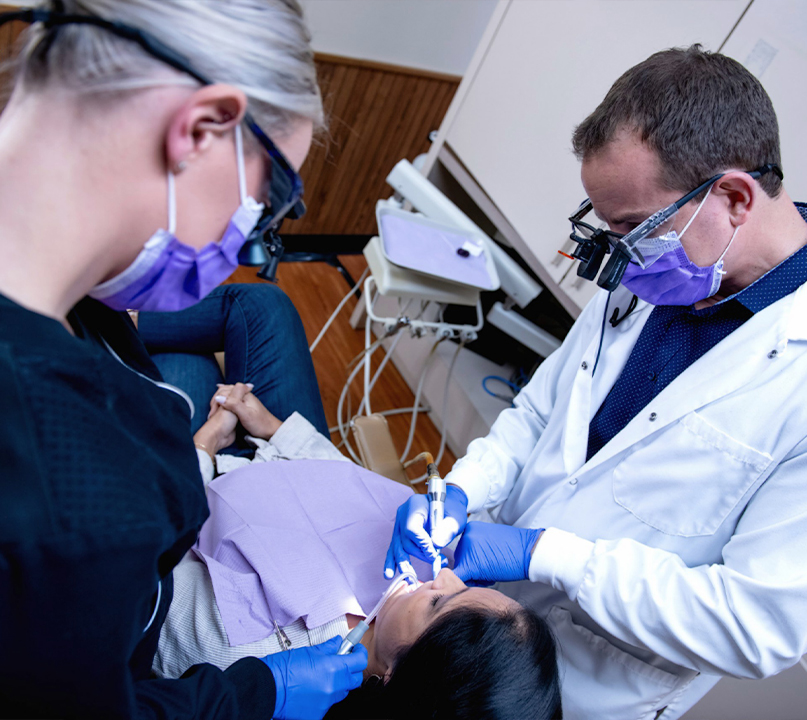 Doctor Young and dental assistant providing dental services in Palos Heights