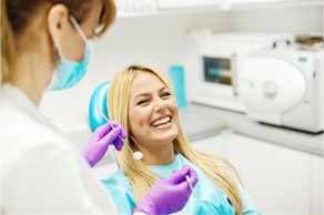 Laughing female patient in dentist’s chair