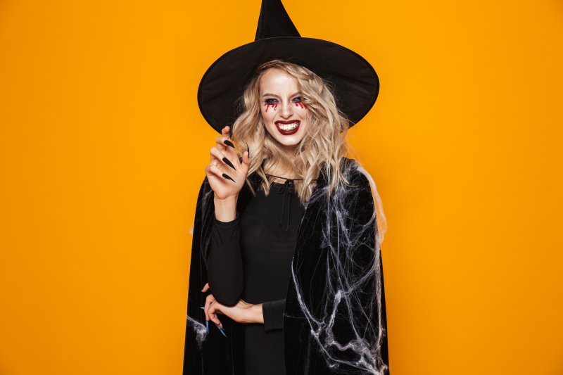 a woman dressed up as a witch for Halloween